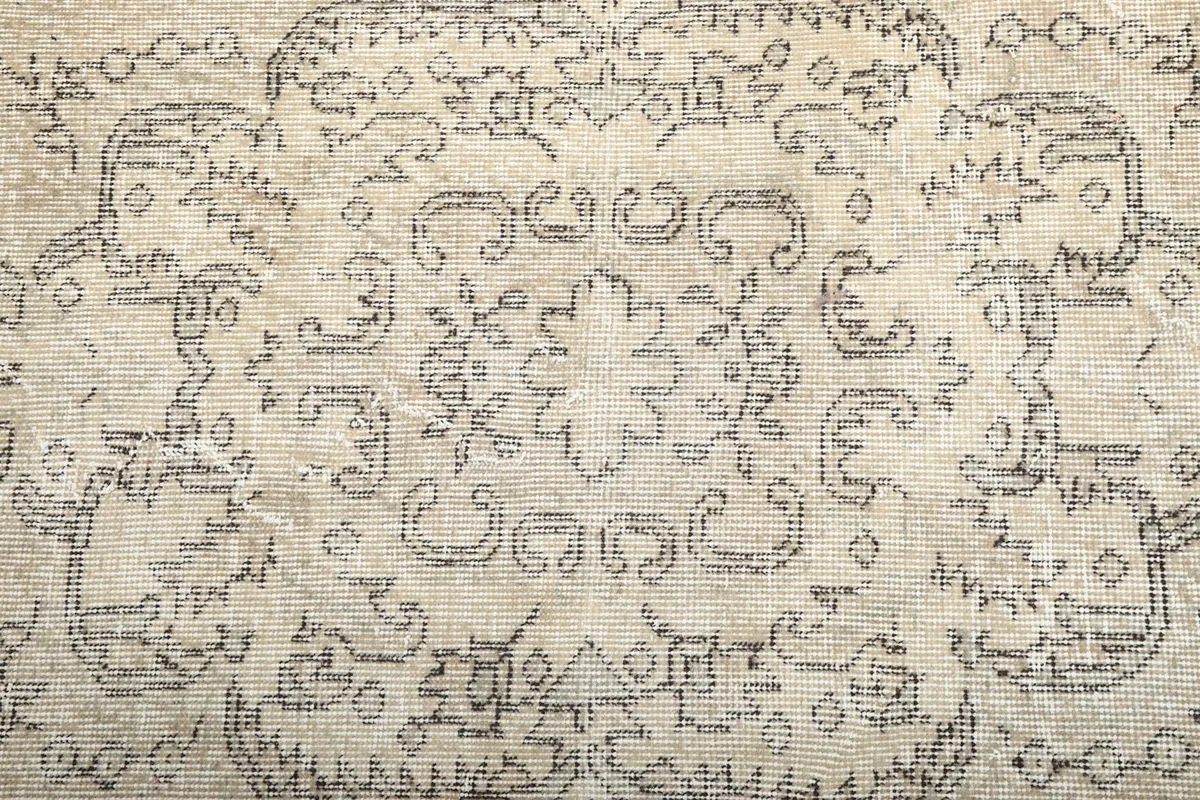 Close-up of the intricate floral and geometric motifs within the rug's design