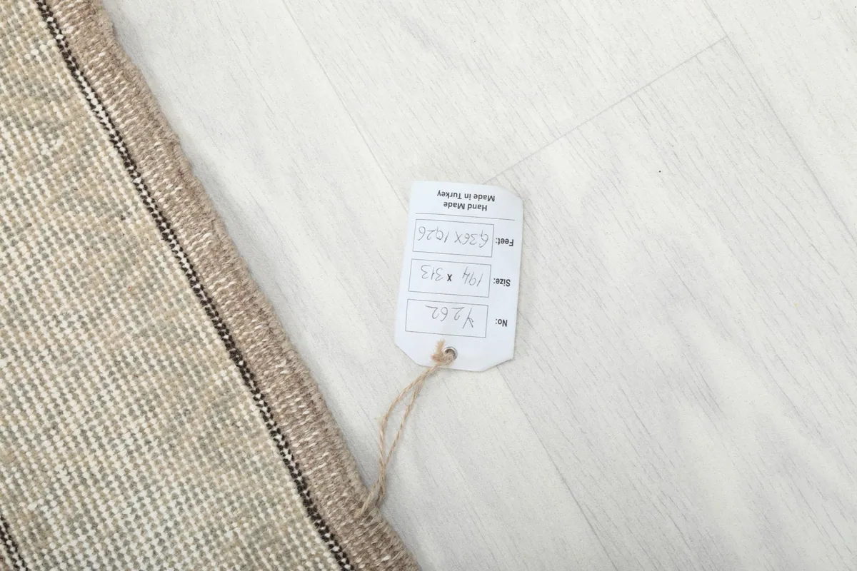 Product tag attached to the rug, displaying size and origin information