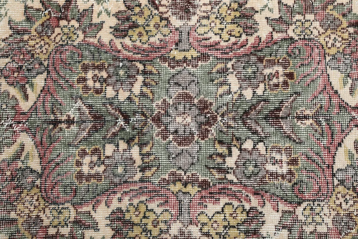 Close-up of the intricate floral and medallion design, showing wool texture and colors
