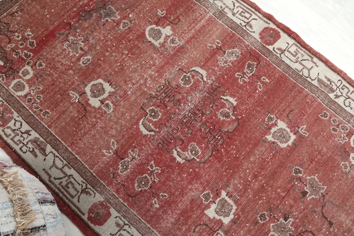Angled view highlighting the vintage patina and intricate floral designs