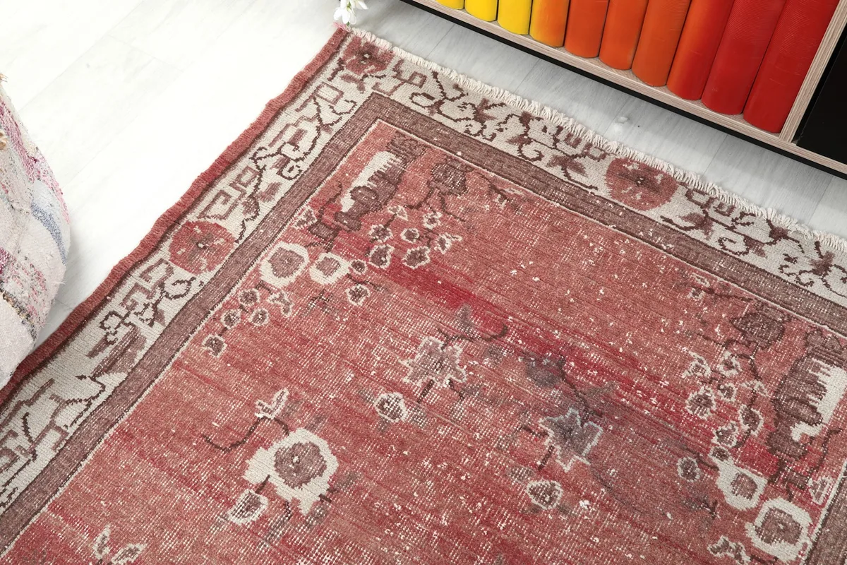 View from above showing the rug's texture and colors next to a colorful bookshelf