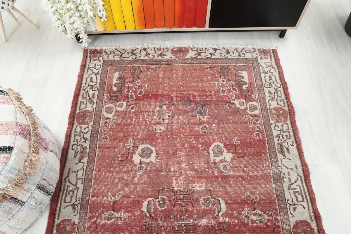 Overhead view of the vintage rust rug, showcasing its full pattern and colors