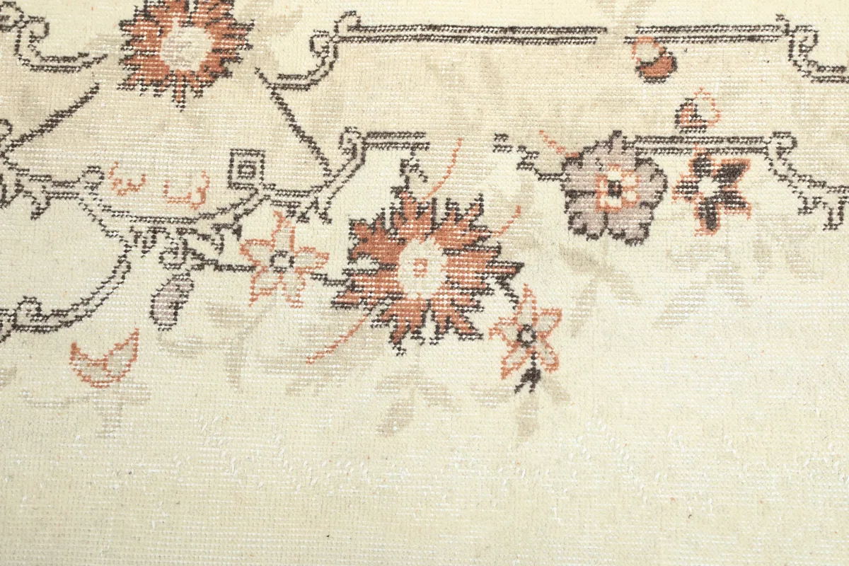 Detailed view of the hand-knotted texture and faded rose and rust colors on the Cream Rose Floral Anatolian Runner.