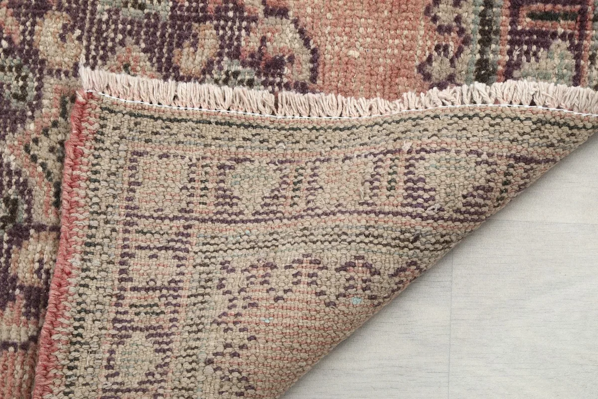 Close-up of the reverse side of the rug, showing the knotting and fringe