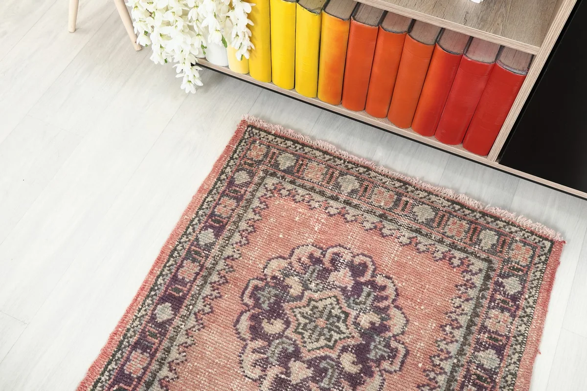 Overhead view of the runner rug, showing the top portion with a bookcase in the background