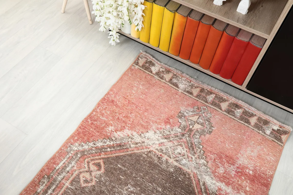 Top-down angle of one end of the runner rug, showing the border and part of a medallion