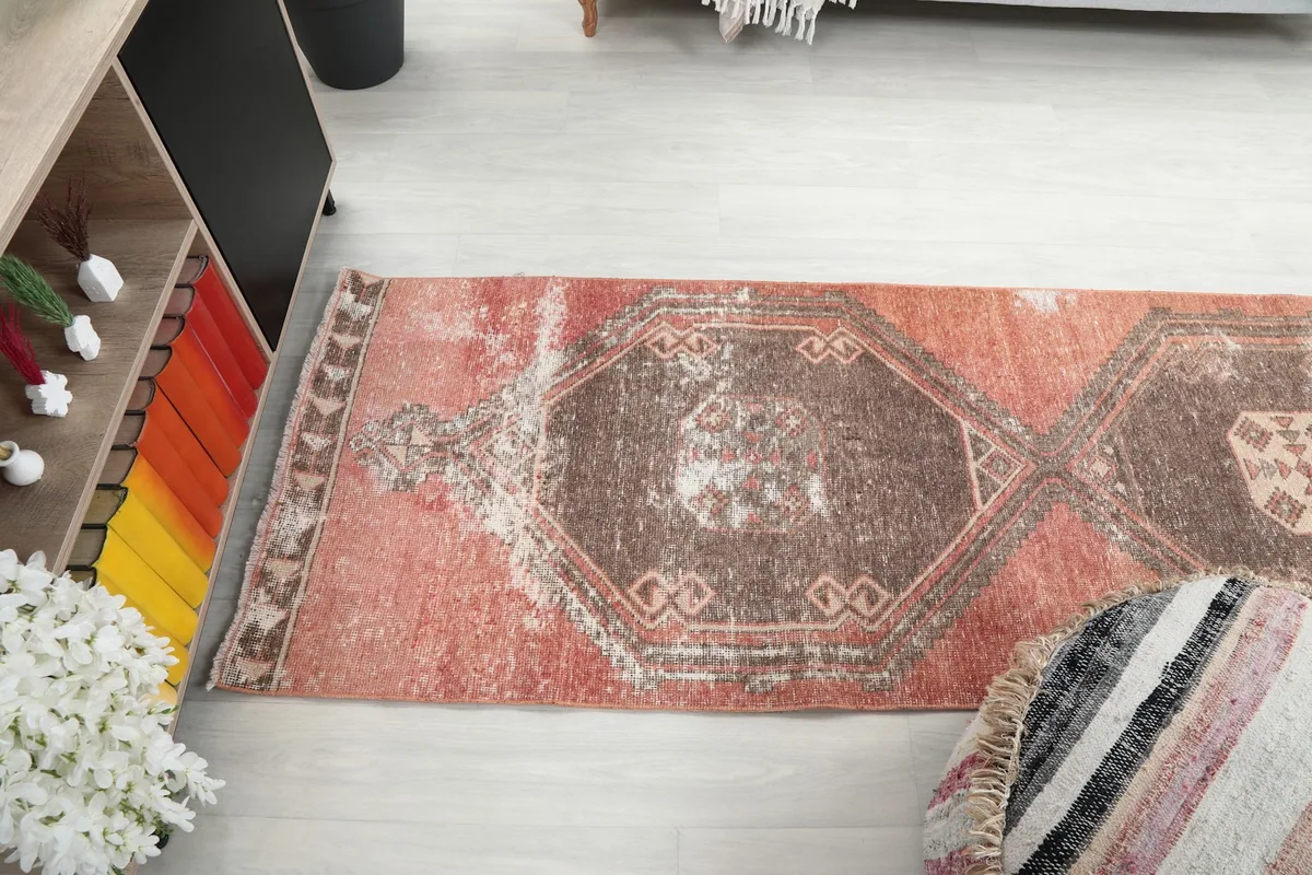 View of the runner rug in a room setting, showing its length and placement relative to furniture