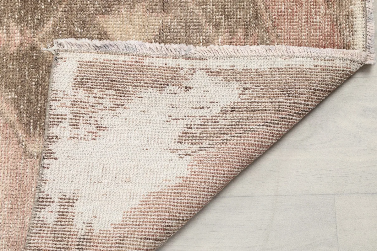 View of the back of the hand-knotted runner, revealing the cotton foundation and construction.