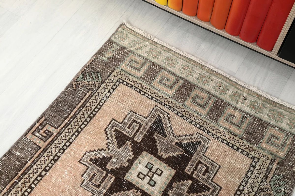 View of one end of the runner rug, showing the border design and color variations