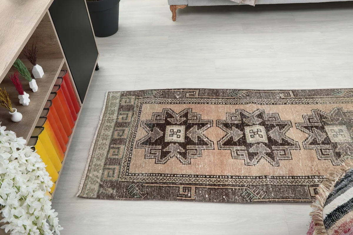 Runner rug laid out in a room, offering a perspective of its full length and design
