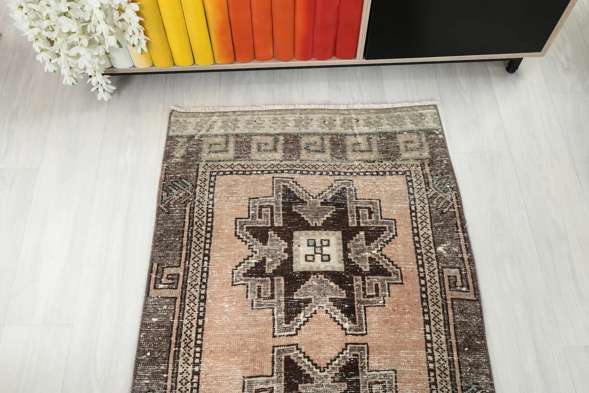 Overhead view of the rug's top section, revealing the repeating geometric design