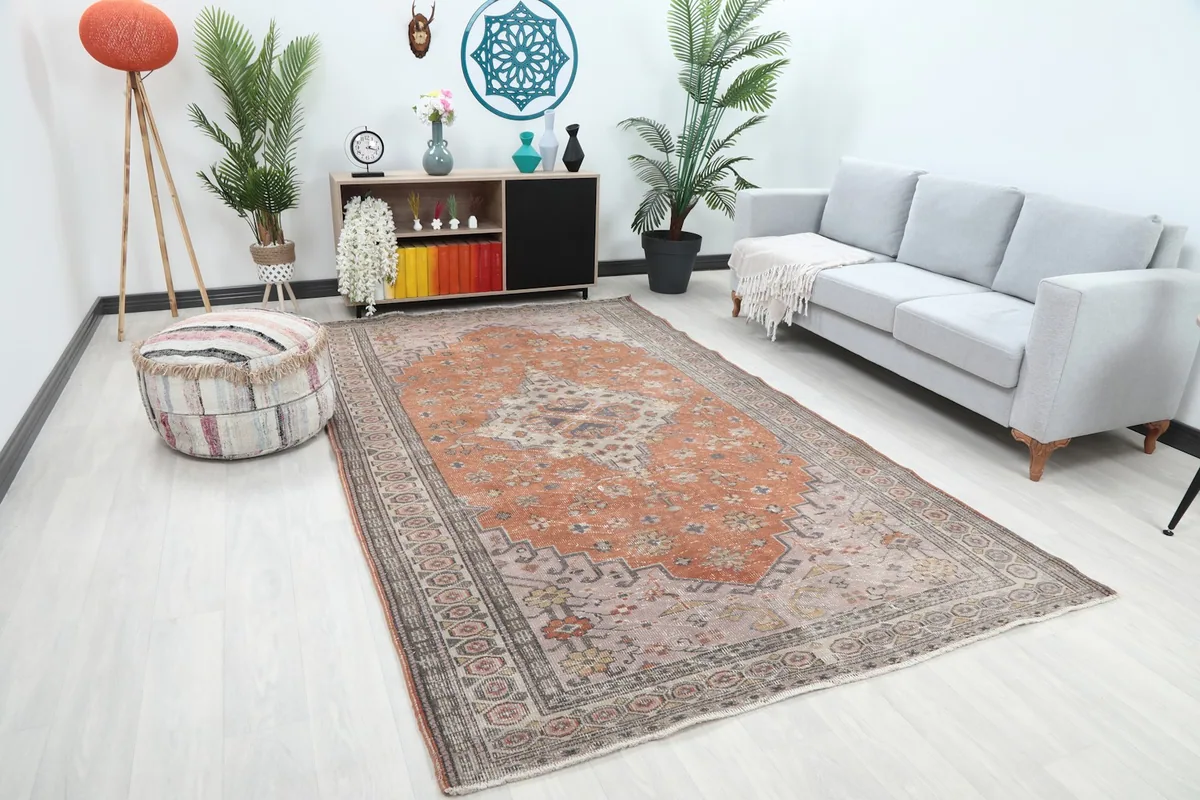 Angled view of the vintage Anatolian rug in a living room, showing its size relative to furniture.
