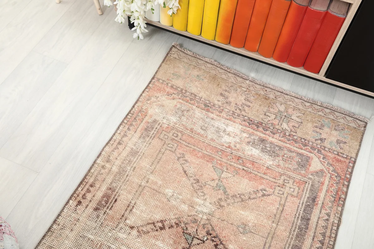 View from above, showing a section of the runner rug with its geometric pattern and subtle color shifts.