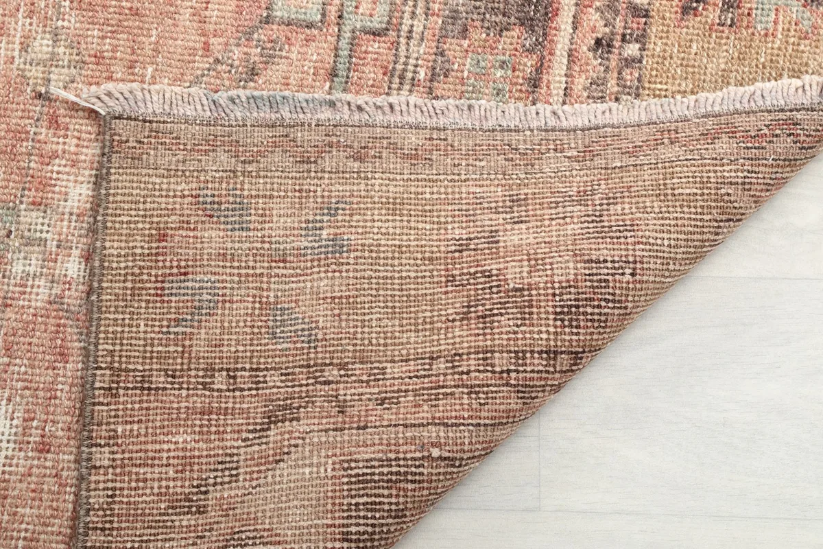 Reverse side of the runner rug, clearly showing the intricate hand-knotting and cotton foundation.