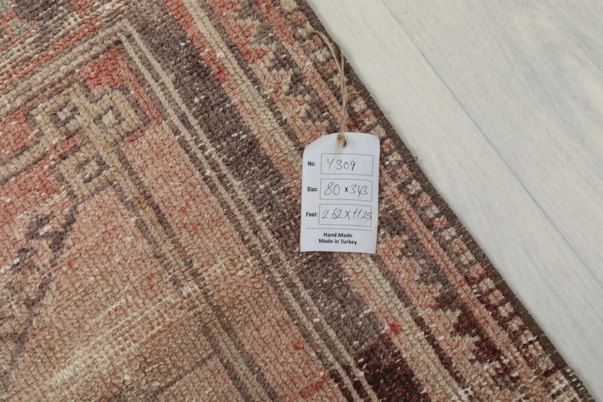 Close-up of the rug's corner with a tag displaying its size and origin, highlighting the hand-knotted quality.