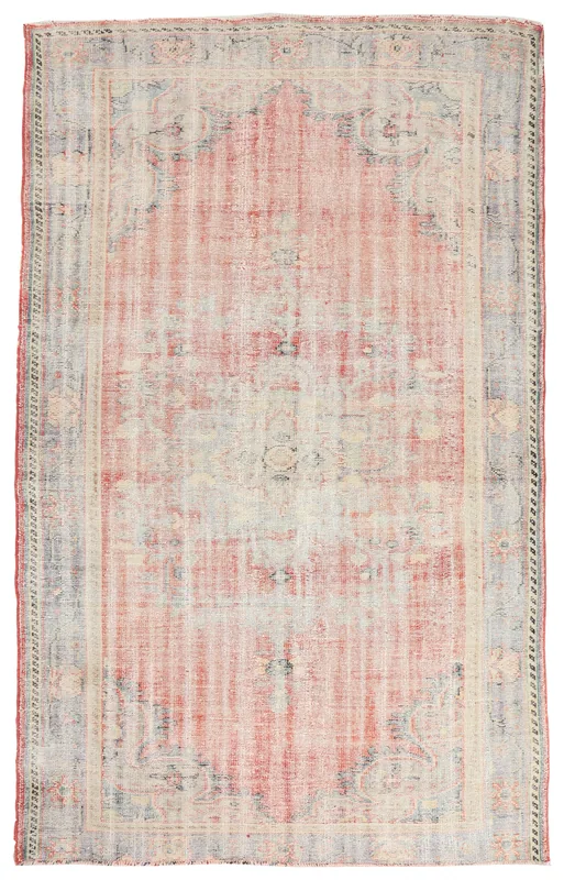 Full overhead view of the vintage rose and charcoal geometric area rug