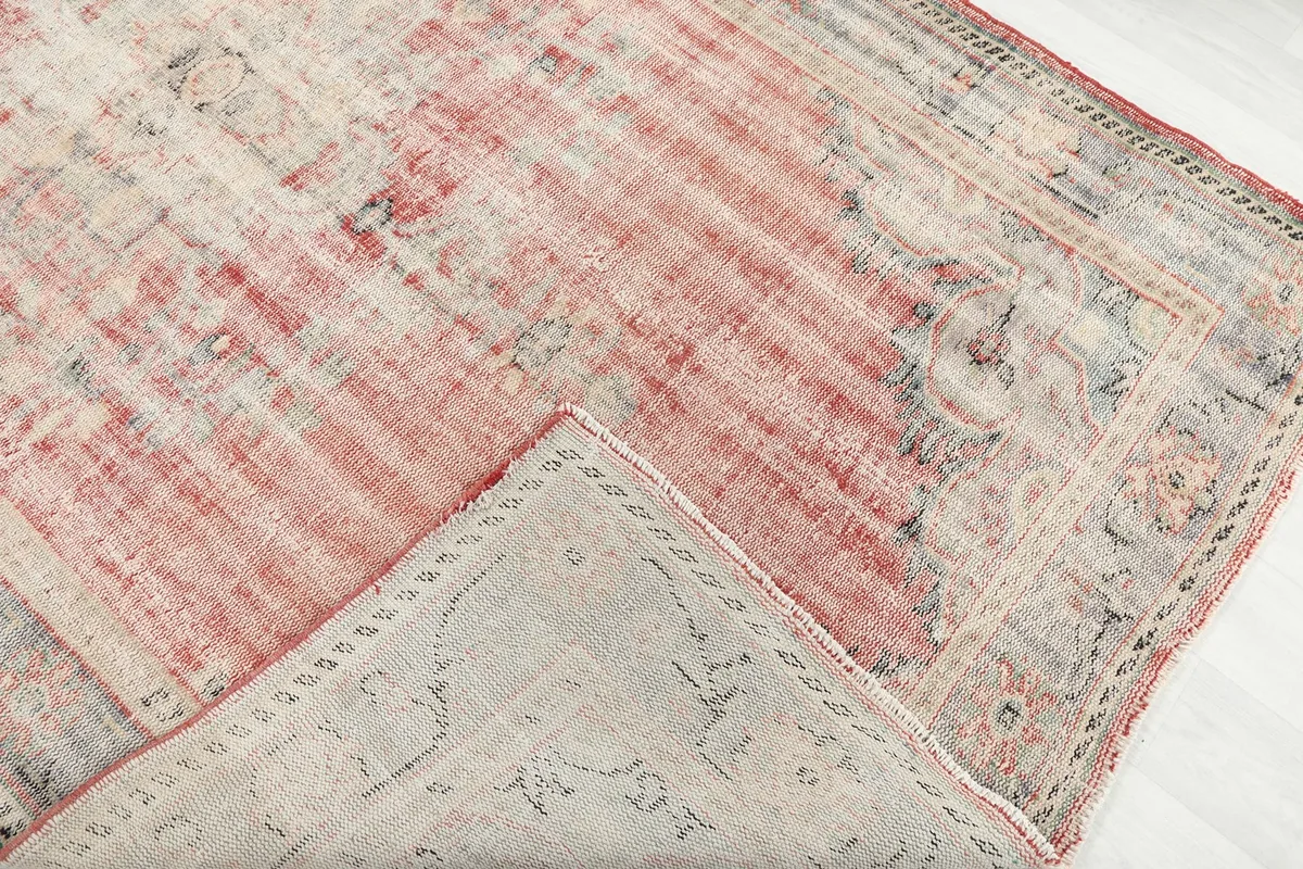 View of the rug's back, revealing the hand-knotted cotton foundation and wool pile