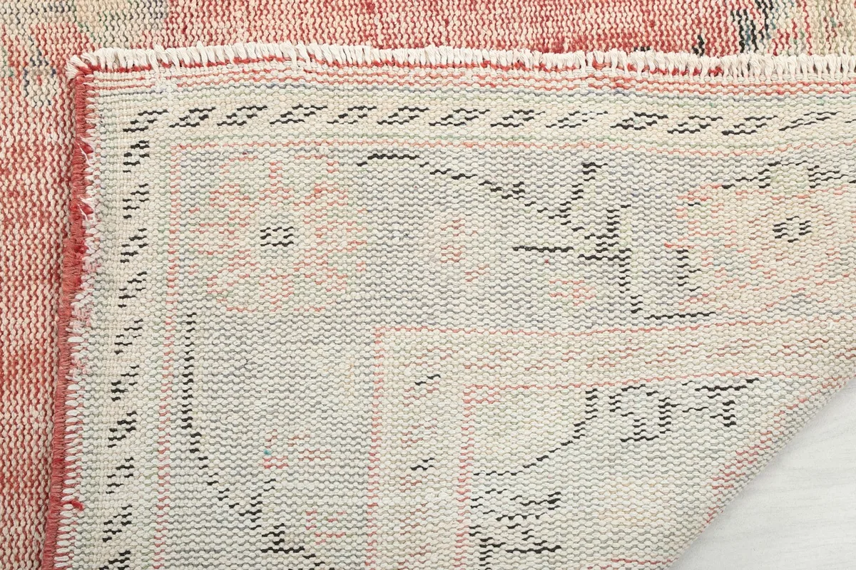 Close-up of the rug's edge, showing the hand-knotted construction and fringe