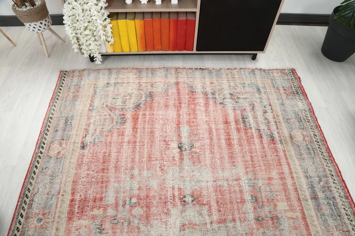 Overhead view of one end of the rug, showing the full width and faded patterns