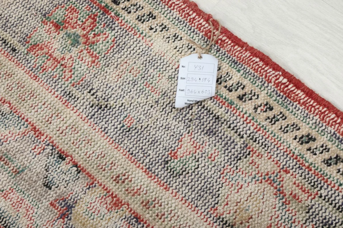 Close-up of the rug's surface with the product tag, showing texture and weave