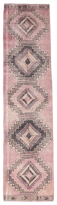 Full overhead view of the rose runner rug with black and tan geometric diamond patterns on a white background.