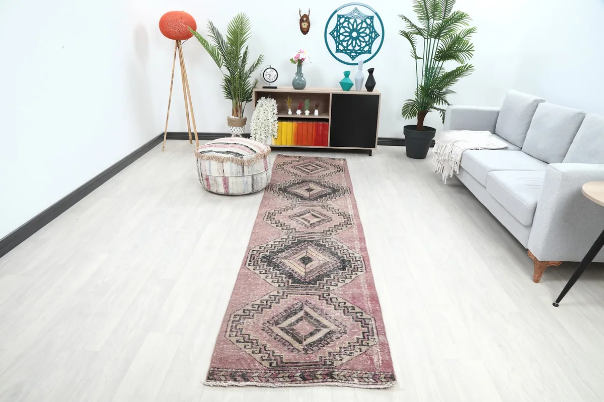 Rose runner rug displayed in a modern living room setting, showing its length and scale.