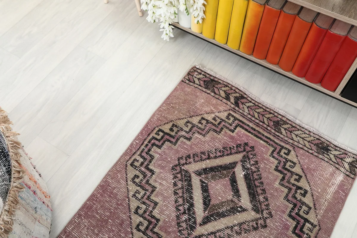 Overhead view of a section of the runner rug, showing the geometric pattern and surrounding room elements.