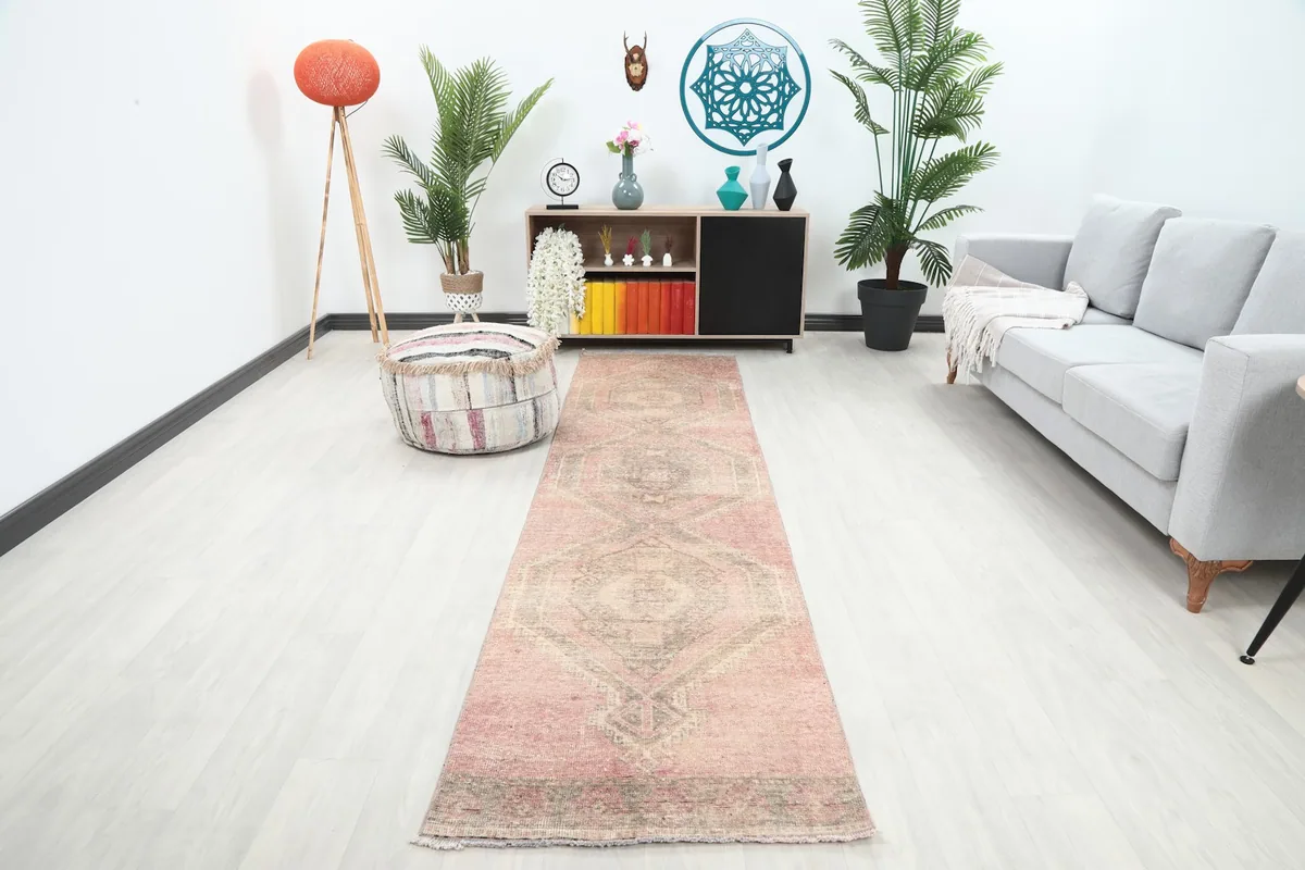 Rose and gray vintage runner rug displayed in a modern living room setting