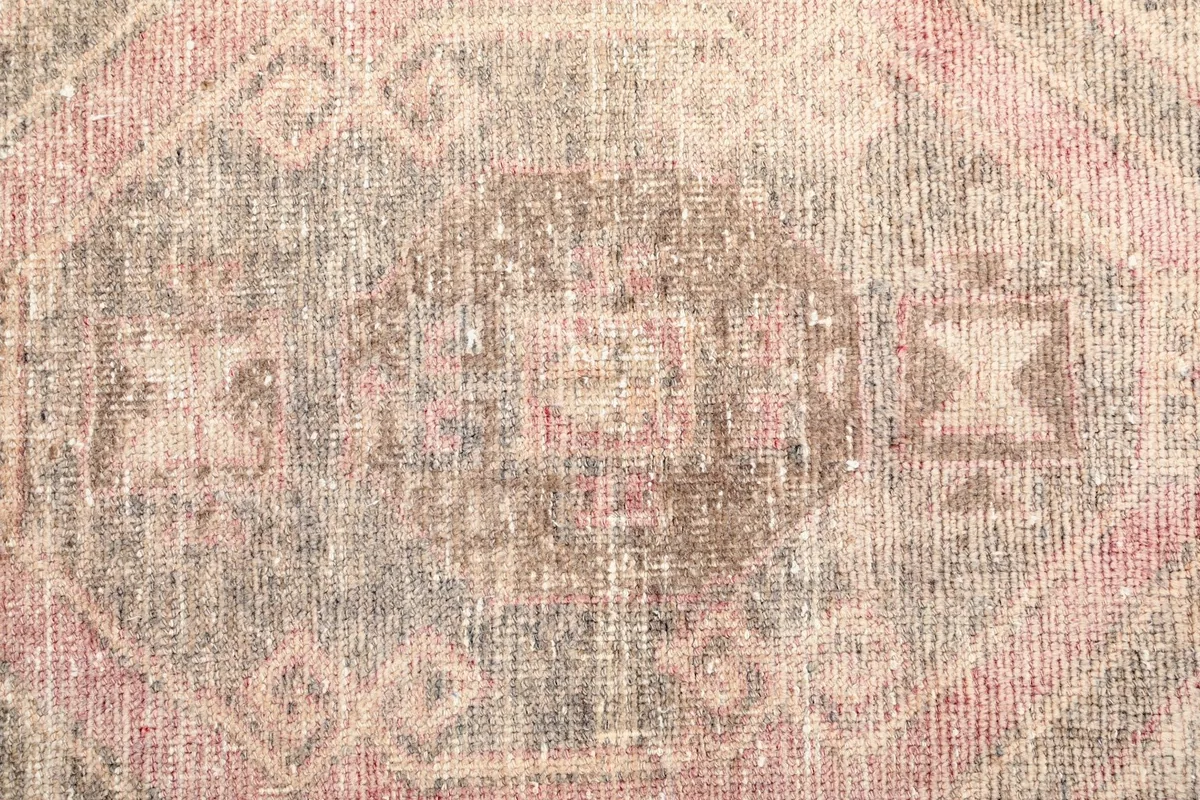 Extreme close-up of the distressed wool pile and intricate geometric motifs