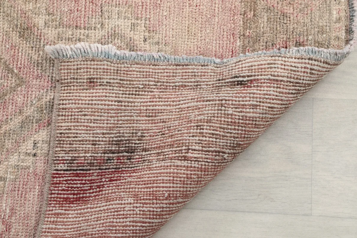 View of the cotton foundation and hand-knotted construction from the back of the rug