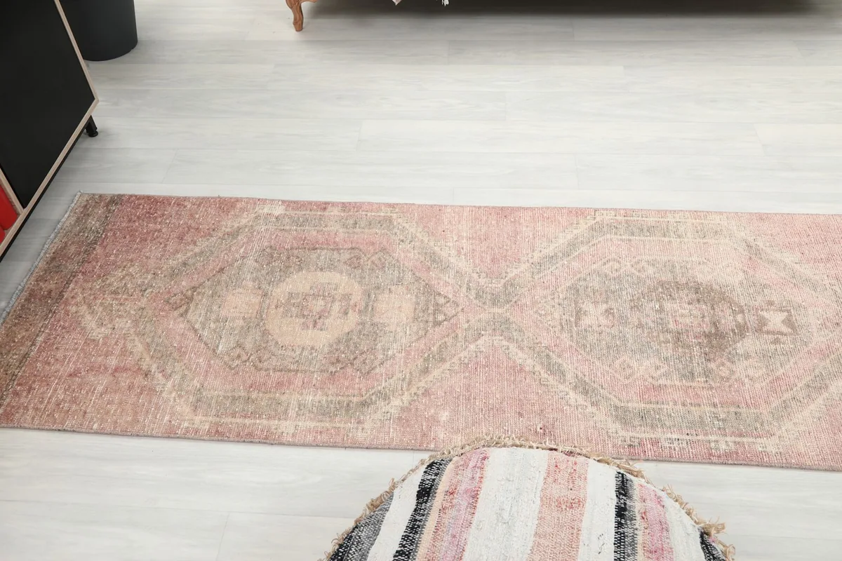 Overhead view showing the full length and geometric design of the rose runner rug