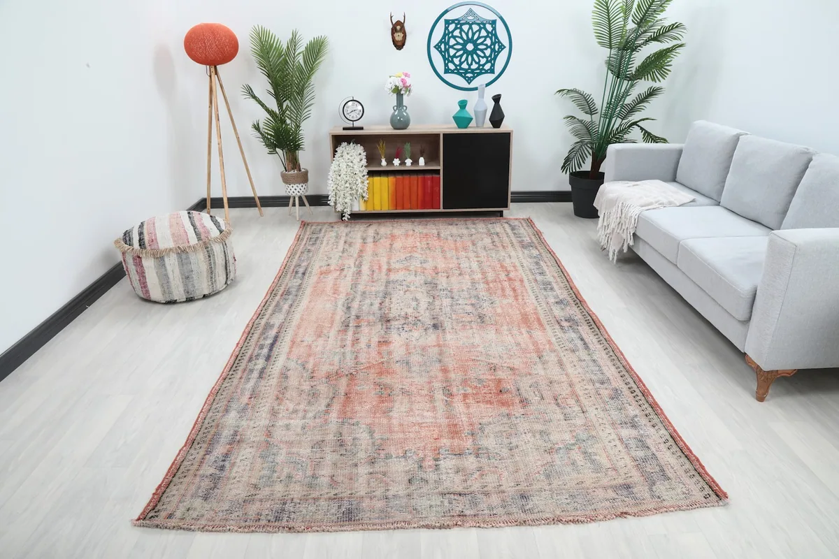 Large vintage rust and blue area rug in a modern living room setting