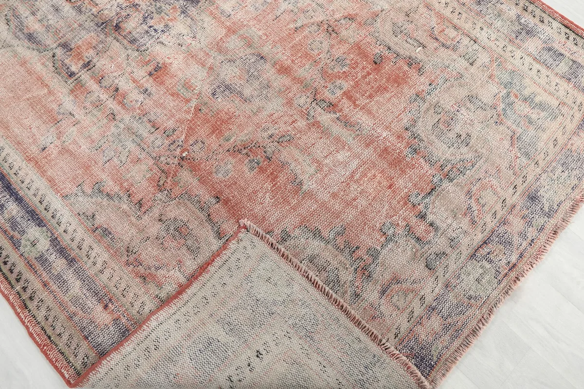 View of the rug folded back, revealing the wool pile and cotton foundation