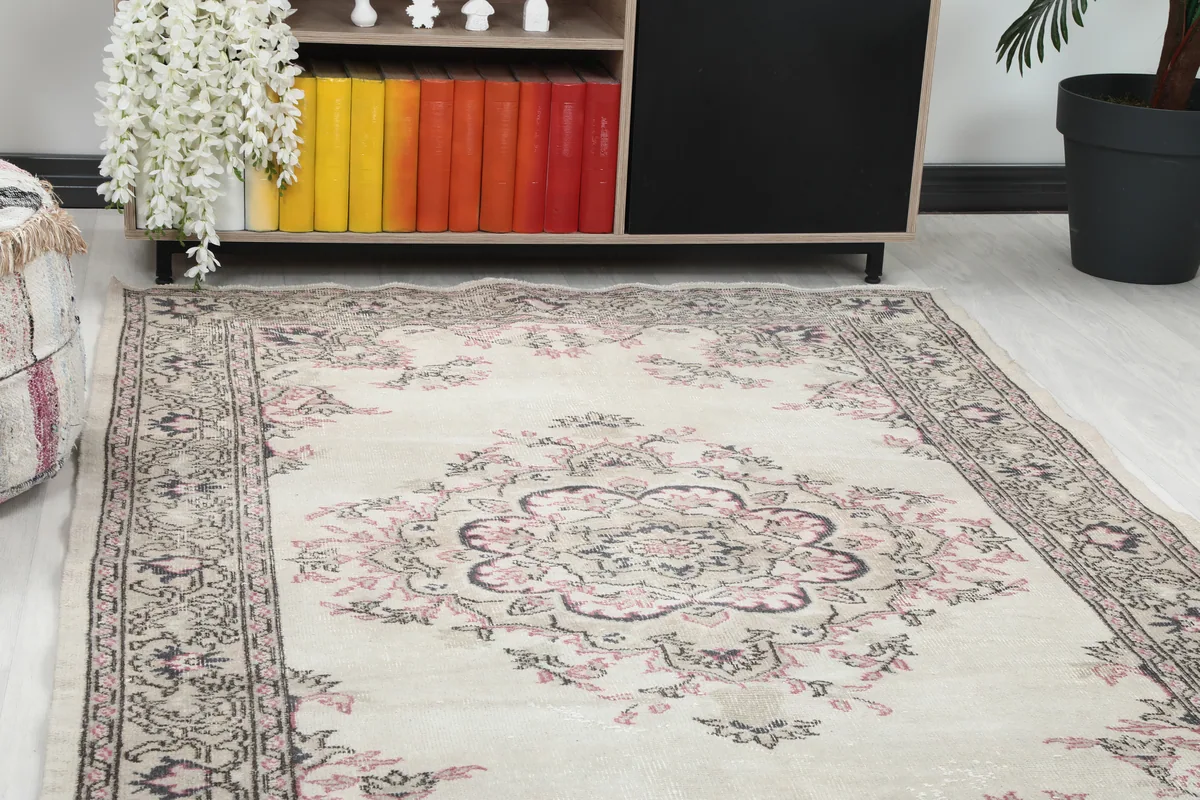 Close-up view of the central medallion and surrounding floral motifs of the Ivory Rose Medallion Anatolian Rug.