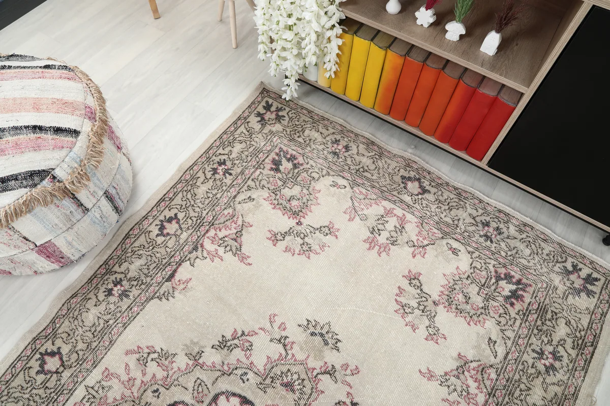Overhead view of the Ivory Rose Medallion Anatolian Rug in a room, showing its placement relative to furniture.