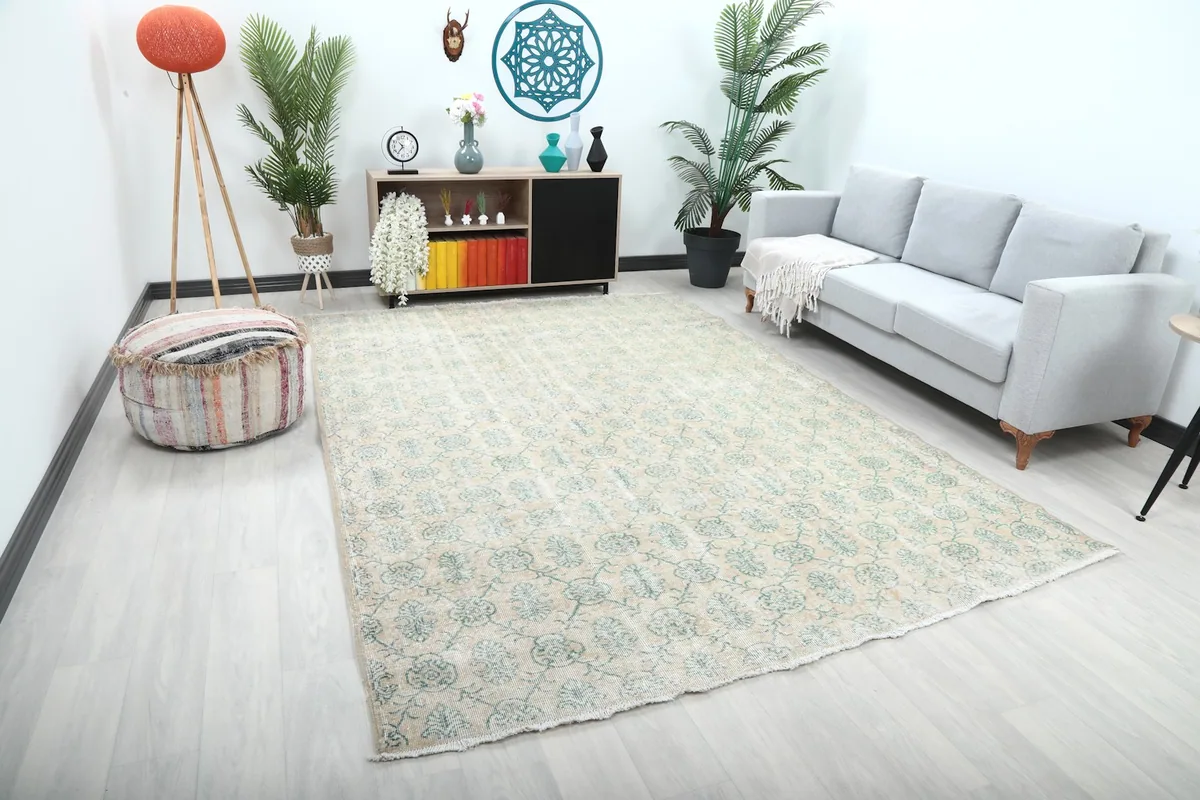 Wide angle view of the beige and green rug placed in a modern living space