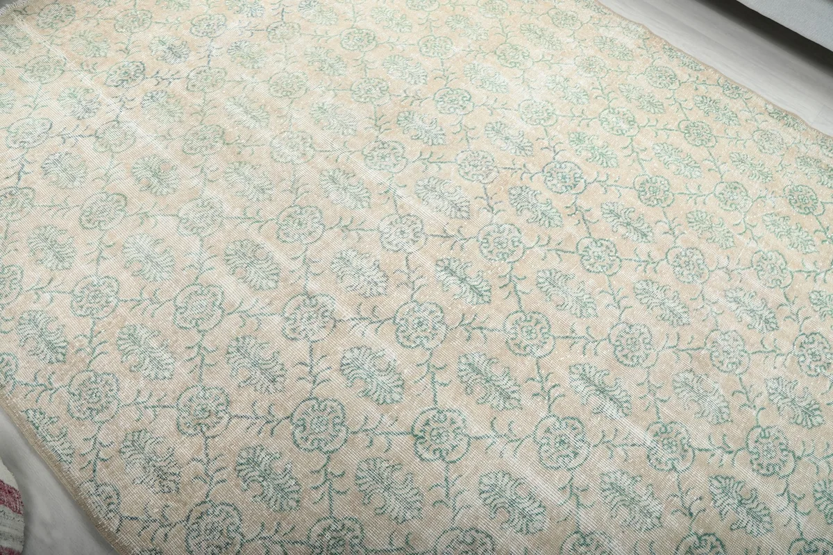 Overhead view of a section of the rug, highlighting the repeating floral design
