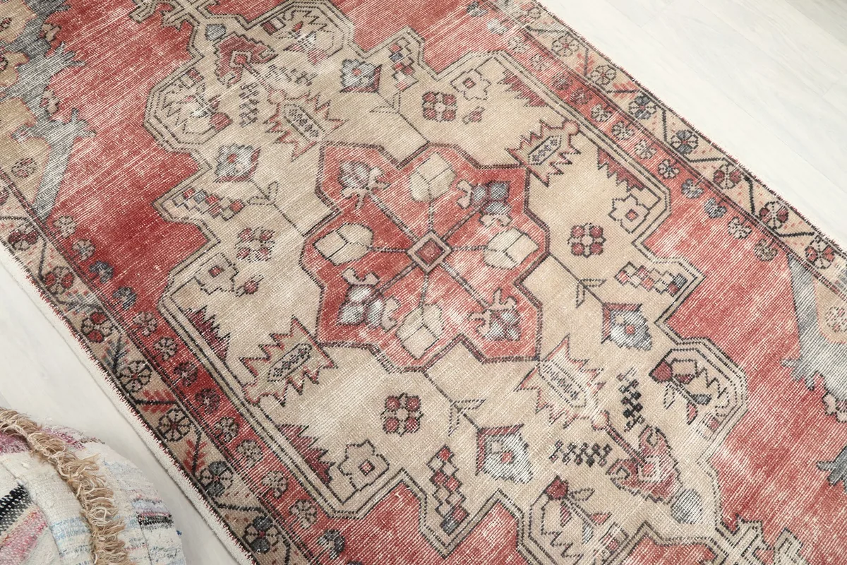 Overhead angle shot highlighting the central beige medallion and surrounding red field
