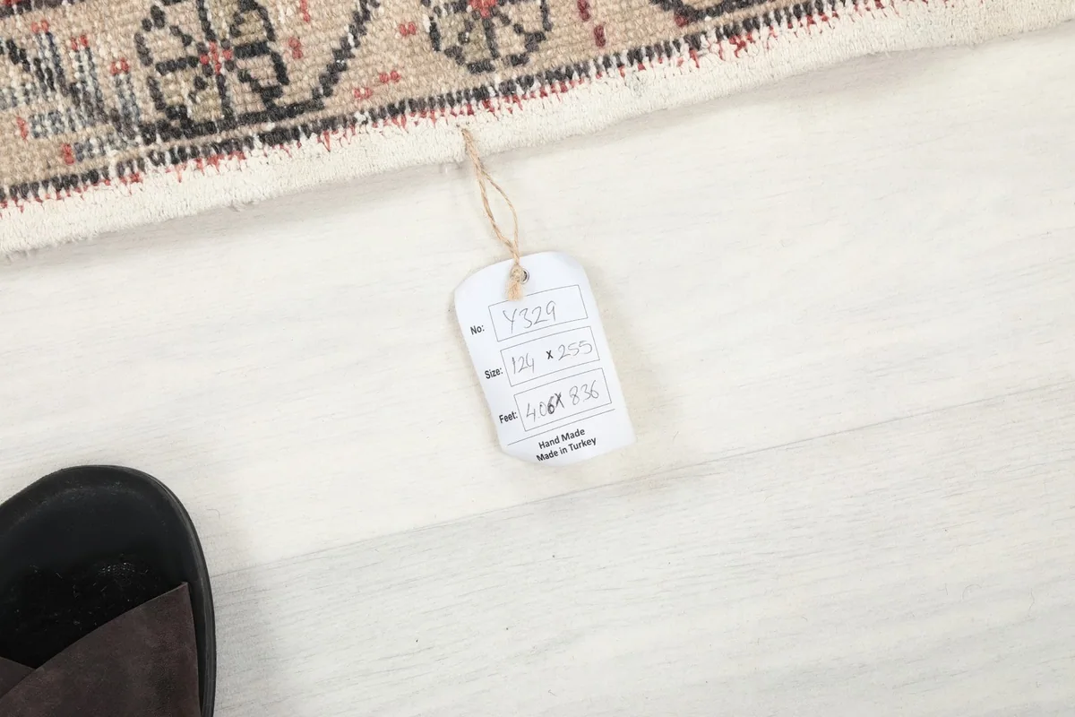 Close-up of the product tag attached to the rug, showing dimensions and origin