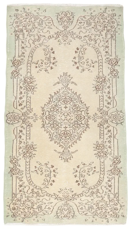 Full top view of the beige and green vintage Anatolian rug with brown medallion