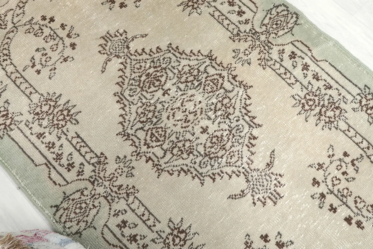 Overhead angle highlighting the rug's distressed texture and central design
