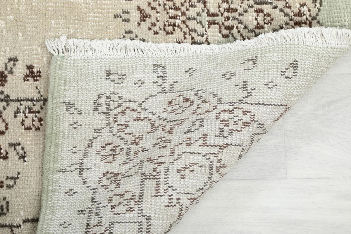Another view of the rug's reverse side and the hand-knotted construction