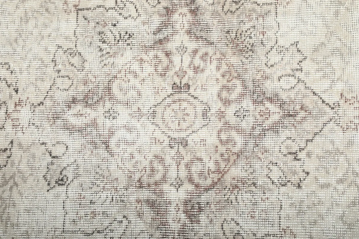 Close-up detail of the central medallion, showing the intricate motifs and variations in color.