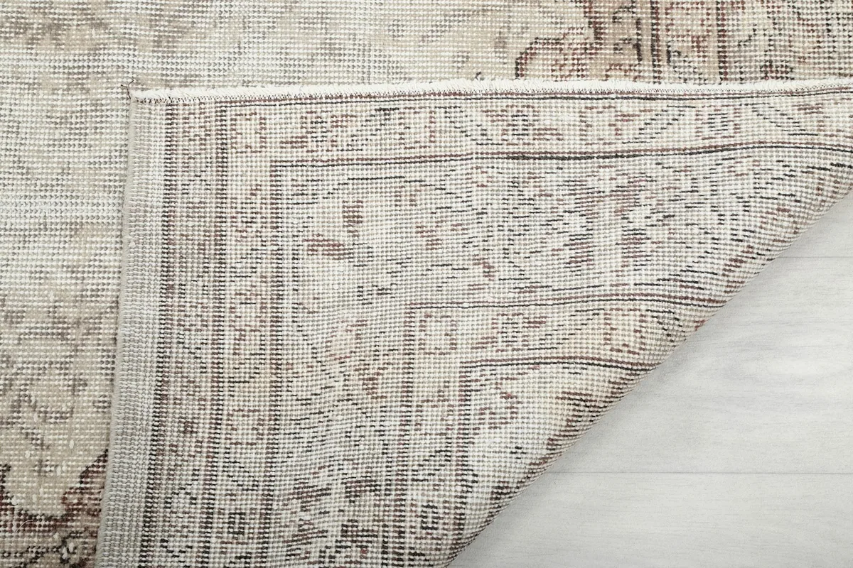 Close-up of the back of the rug, showing the dense hand-knotted weave and cotton foundation.