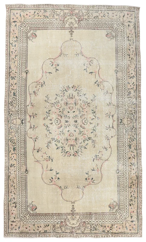 Full overhead view of the beige and rose floral medallion vintage Anatolian rug