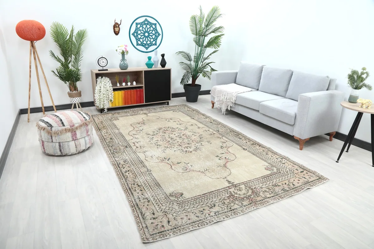 Angle view of the beige vintage rug in a modern living space with light sofa