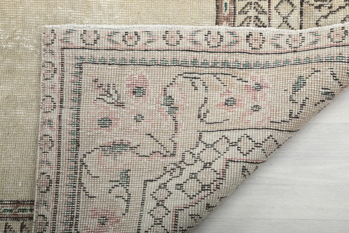 Underside detail of the rug, showing the reverse of the hand-knotted wool on cotton