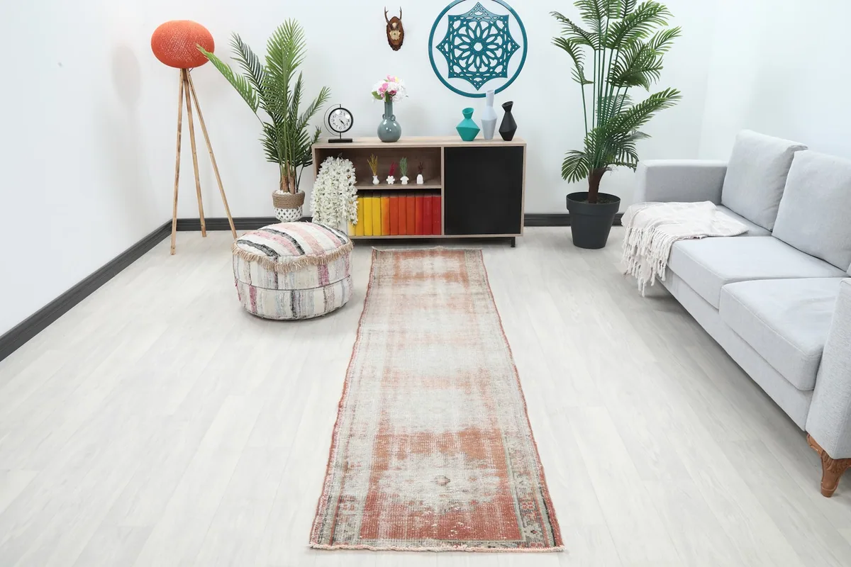 Vintage Anatolian runner rug in a modern living space with light flooring and furniture