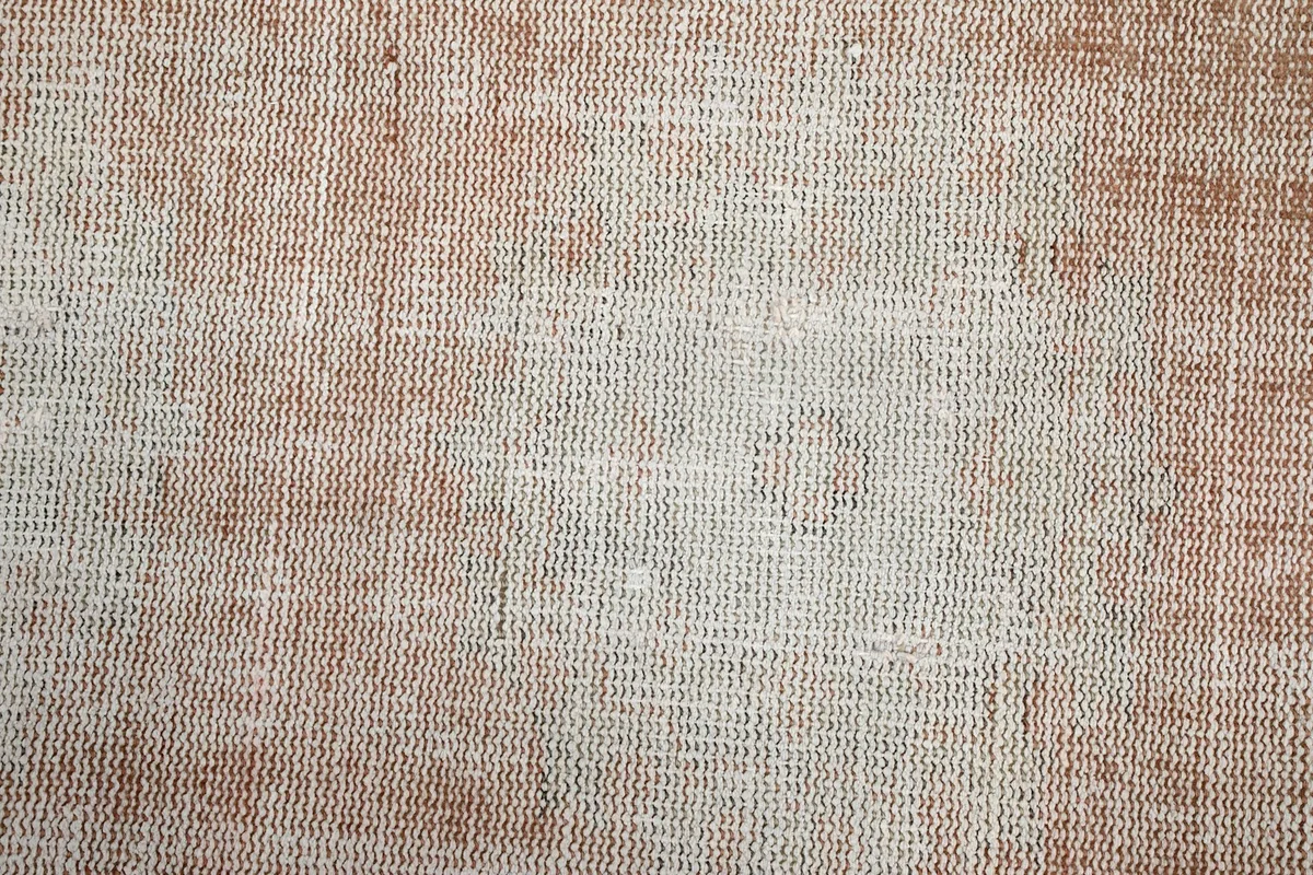 Close-up of the low wool pile, showing the texture and subtle color blending of the rug