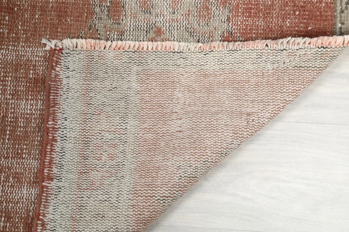 Underside view of the hand-knotted cotton foundation and fringe of the vintage runner